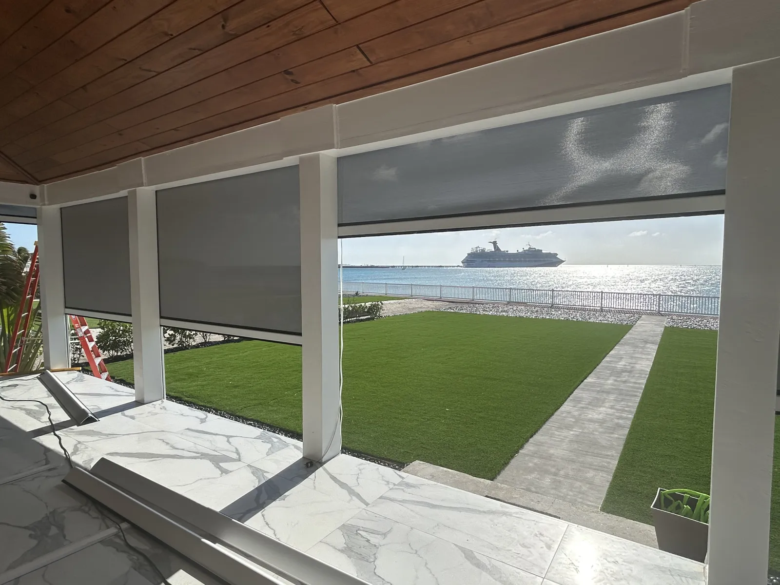 Motorized screens on a patio with ocean view